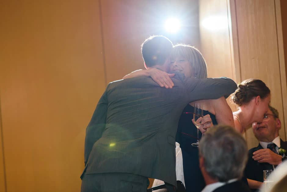 groom hugging mother