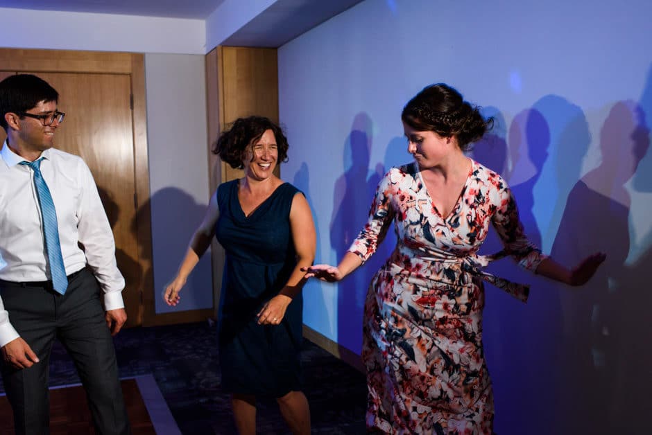 guests dancing at dramatically lit reception