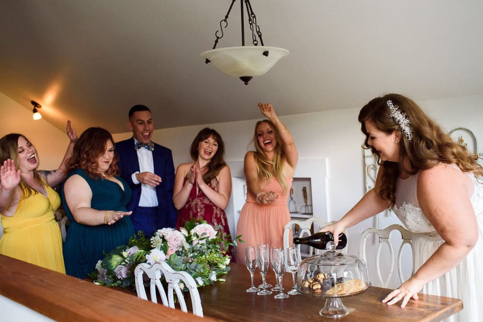 wedding party celebrating champage pour