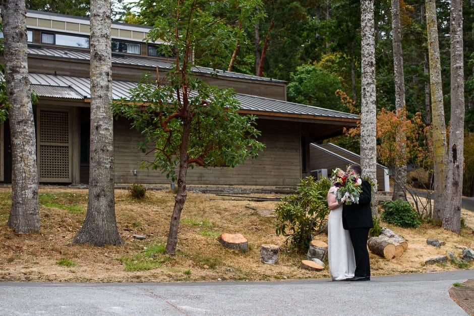 couple kissing behind flowers