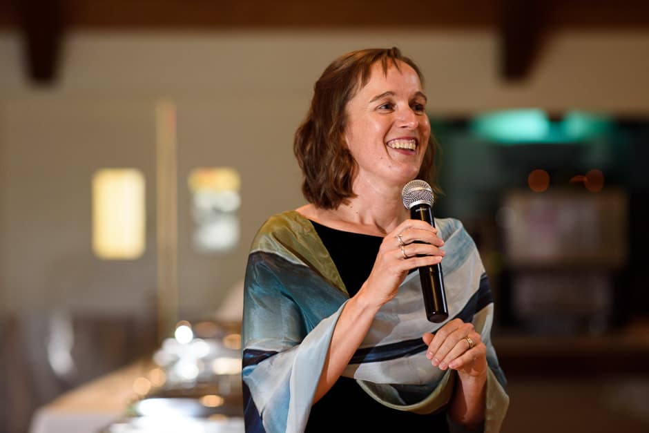 bride's sister laughing during wedding toast