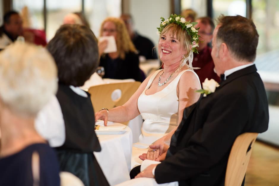 bride smiling during wedding toast