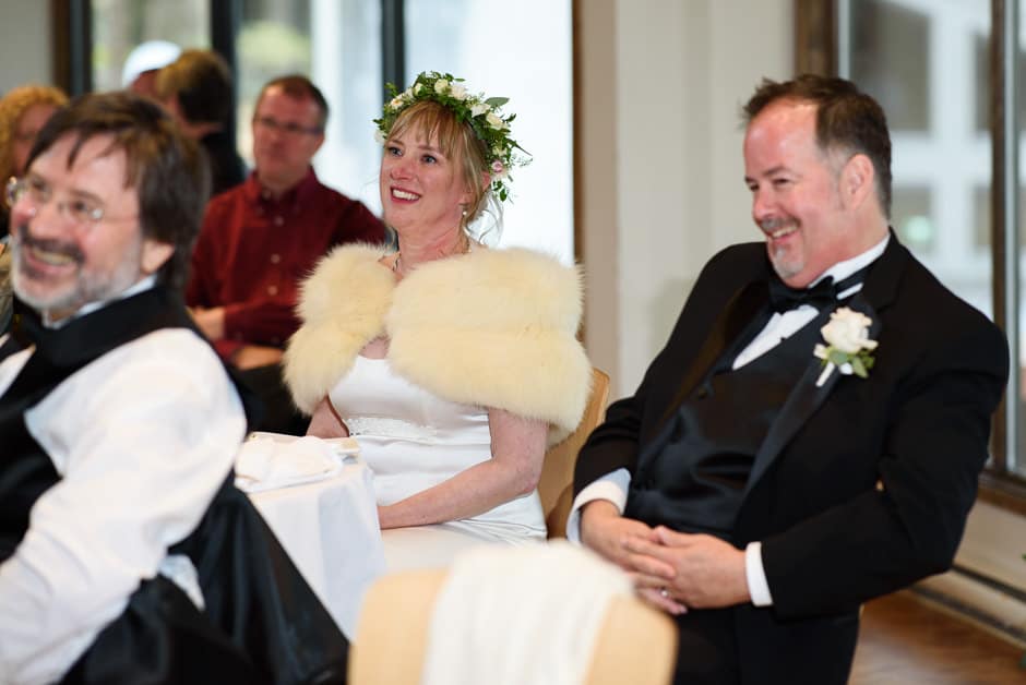 bride and groom listening to toasts