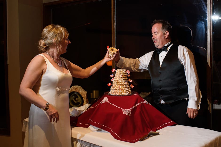 couple breaking danish wedding cake