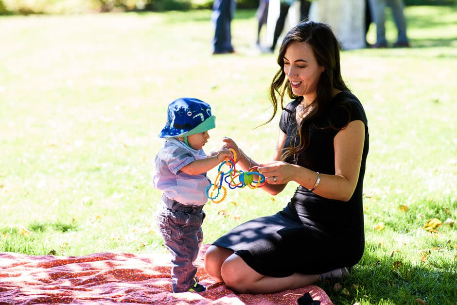 guest playing with baby at cocktail hour