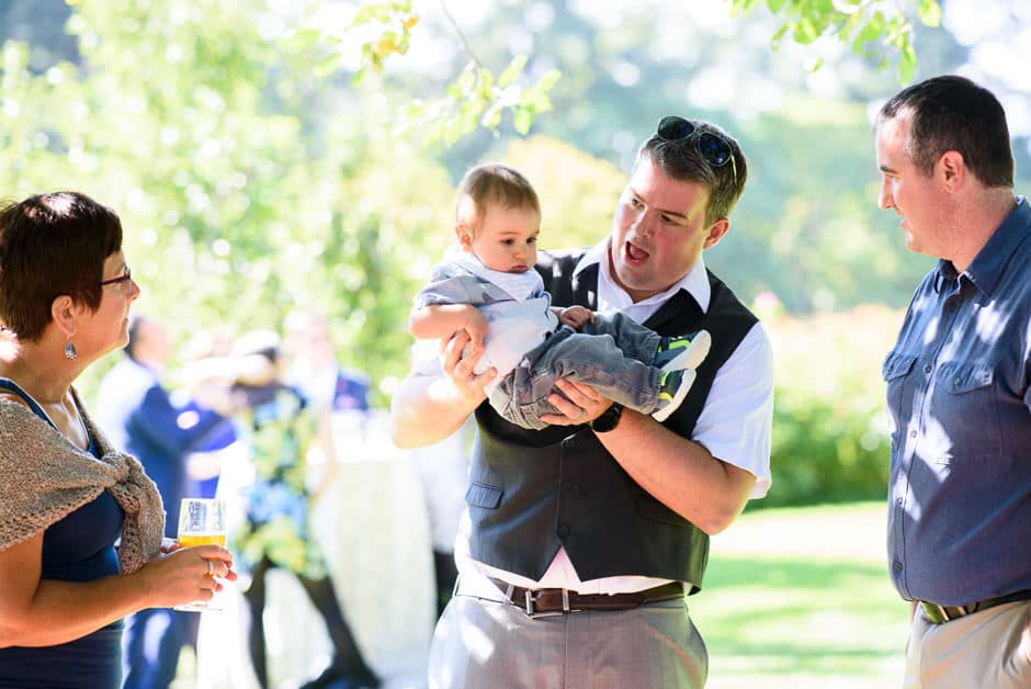 groom making silly face at baby