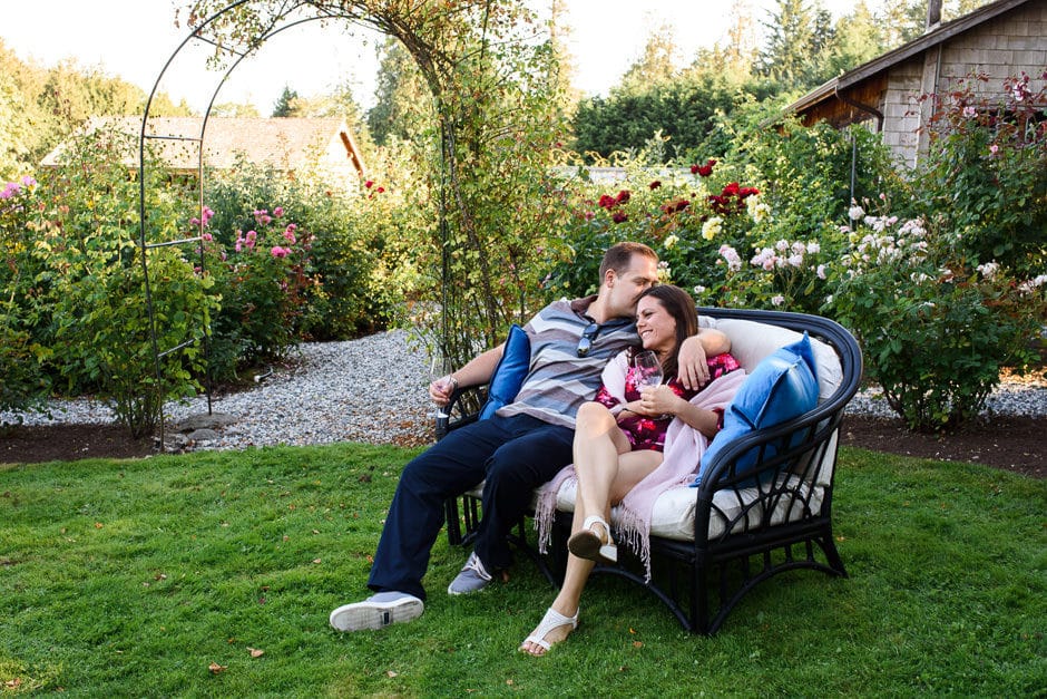 couple cuddling in outdoor wedding lounge