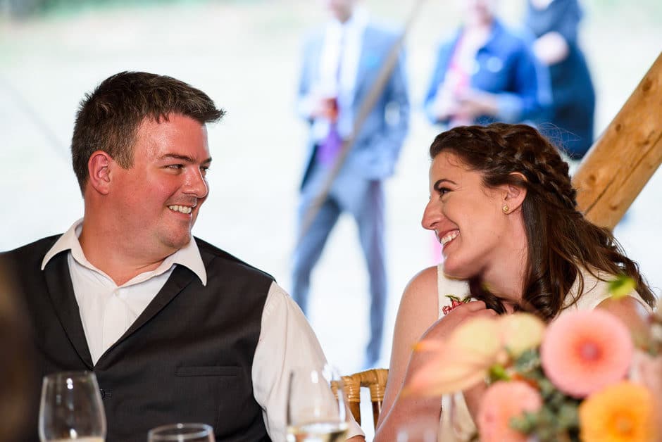 couple smiling at each other during toasts