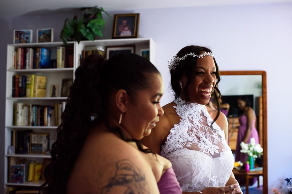 bride and bridesmaids laughing before wedding